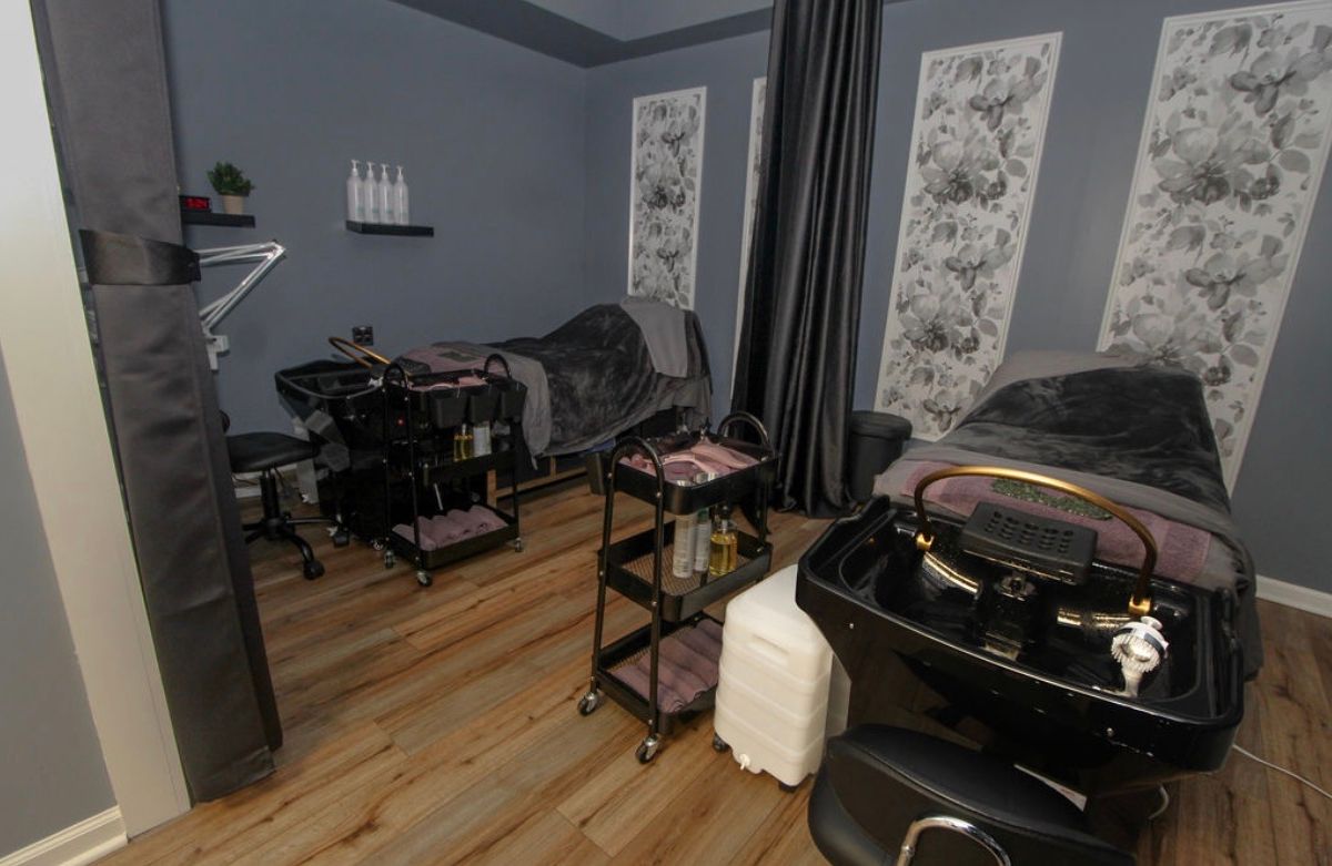 Spa treatment room at Shear Serenity with treatment beds and decor